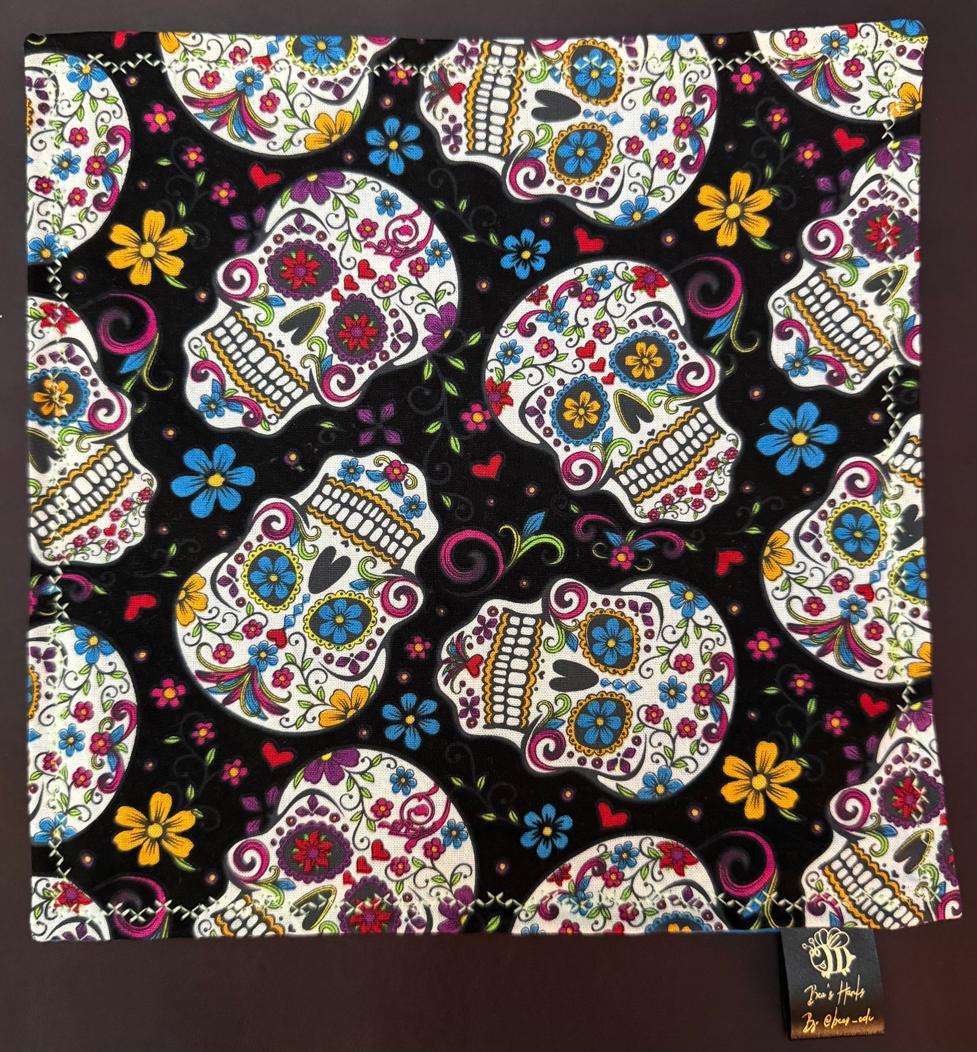 Sugar skulls with blue cotton / black microfiber backing edc hank with glow thread.