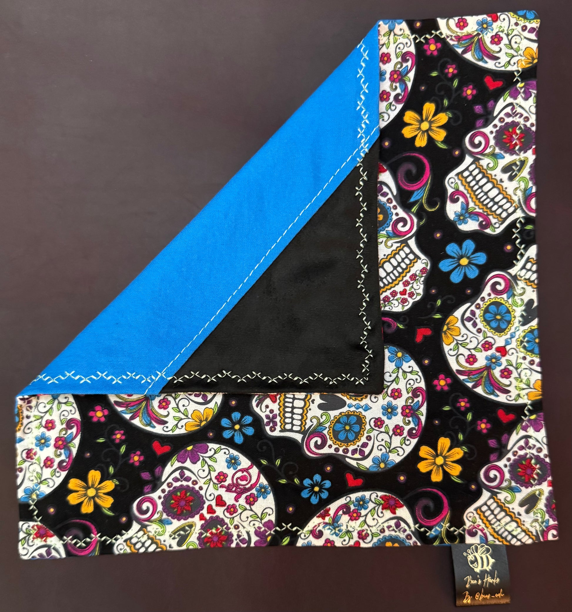Sugar skulls with blue cotton / black microfiber backing edc hank with glow thread.