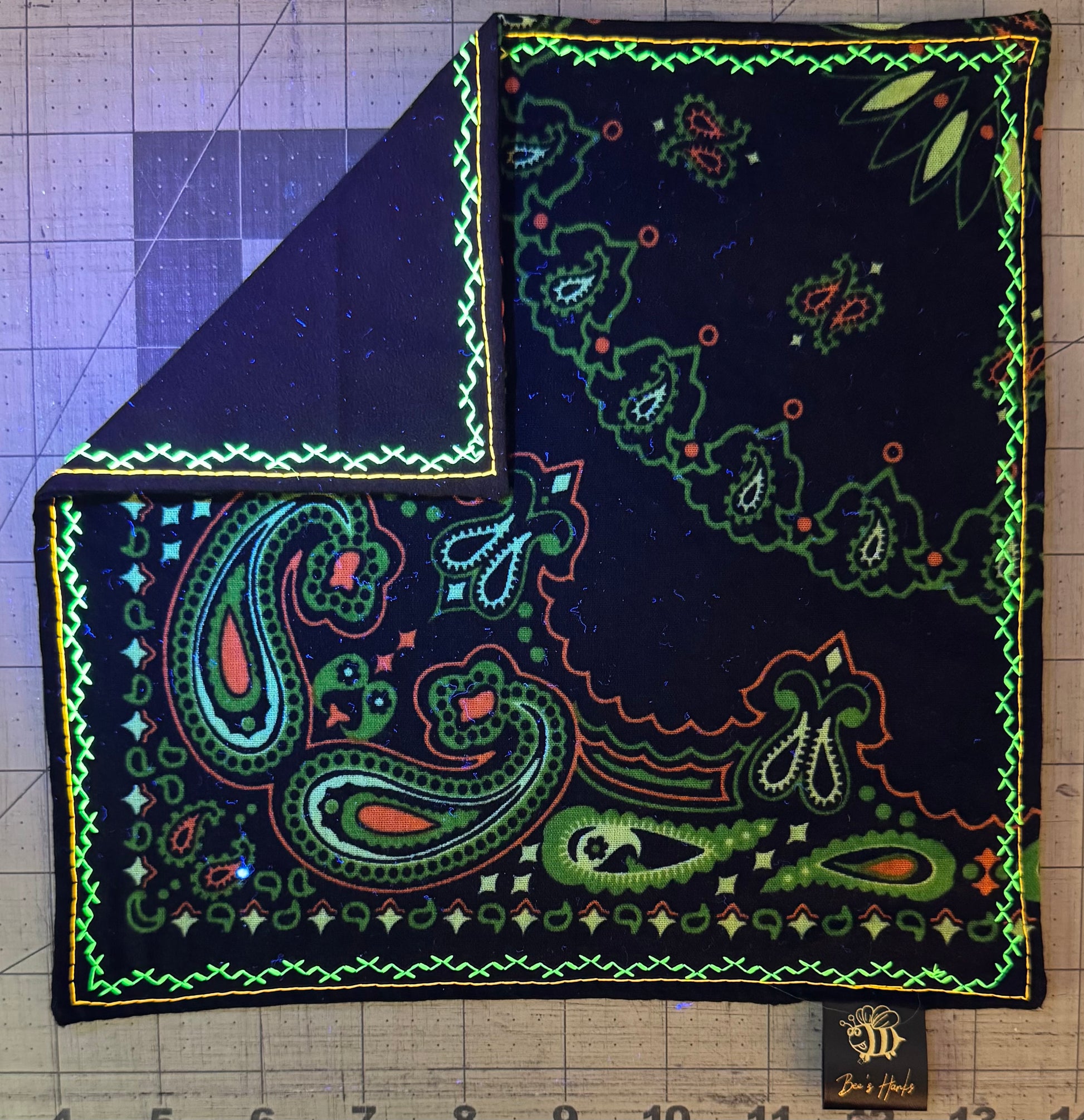 Neon green and orange paisley edc hank with glow thread.
