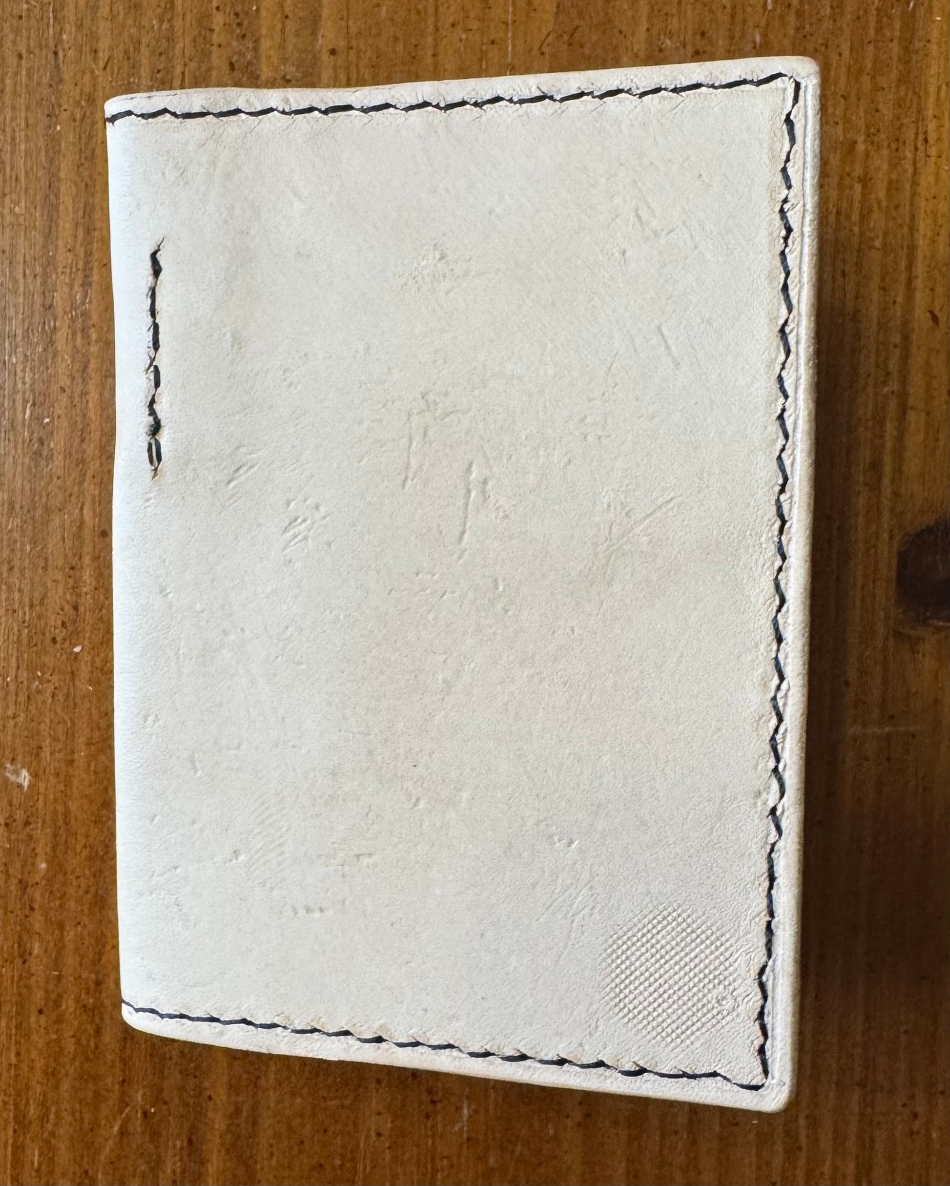 Leather pocket notebook cover/wallet with internal pen loop.