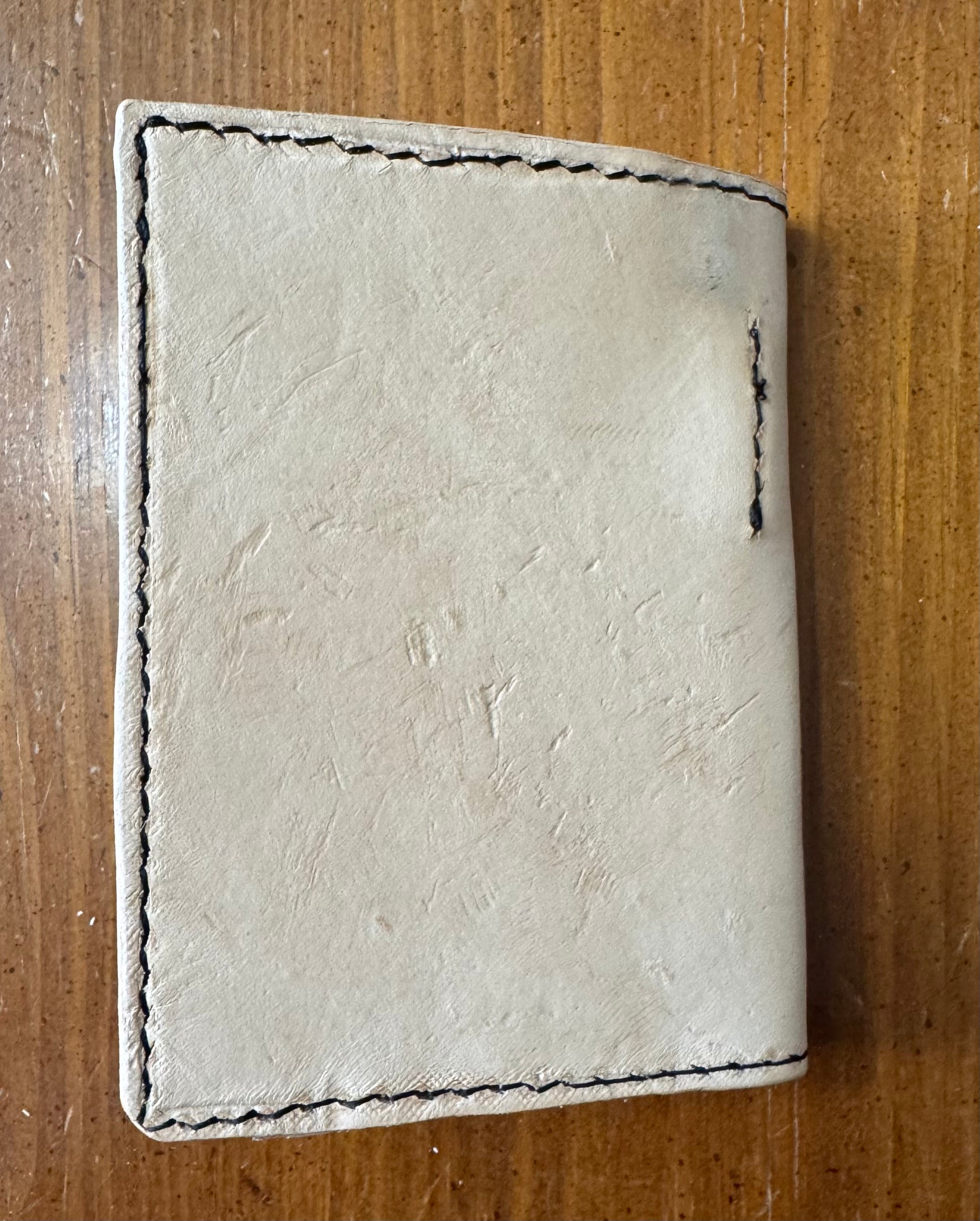 Leather pocket notebook cover/wallet with internal pen loop.