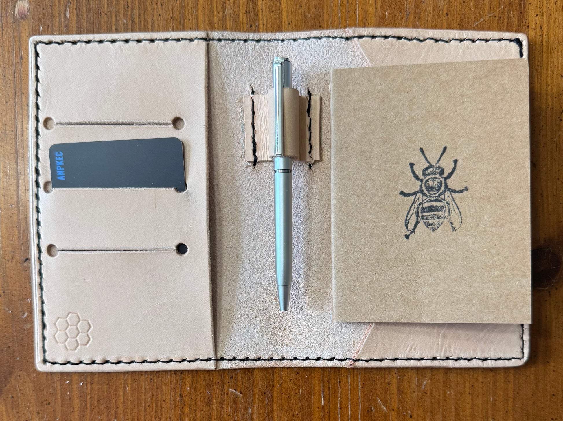 Leather pocket notebook cover/wallet with internal pen loop.